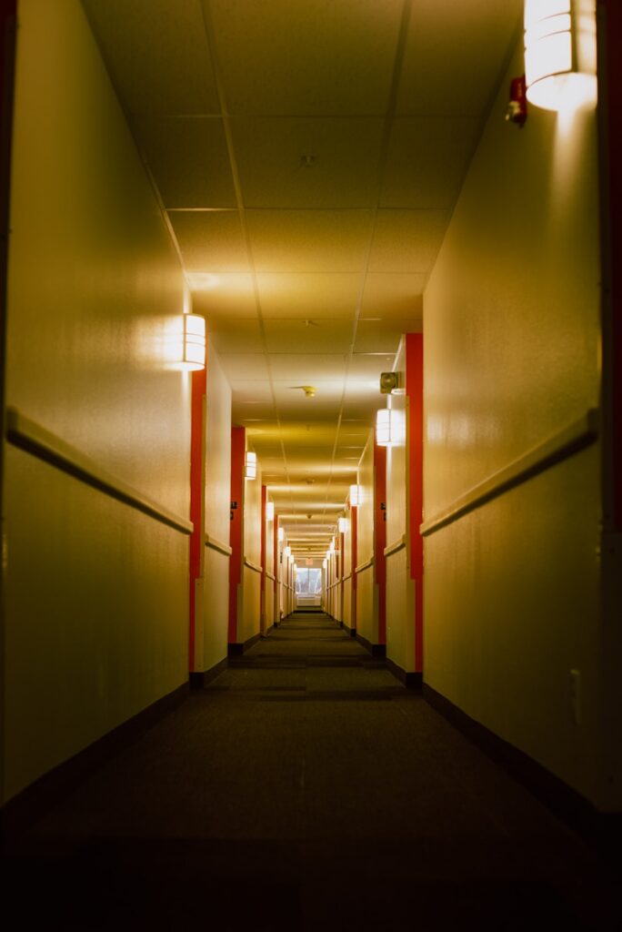 a long hallway with red and white columns