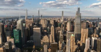 Stunning aerial view of Manhattan's iconic skyline featuring modern skyscrapers and vibrant city life.