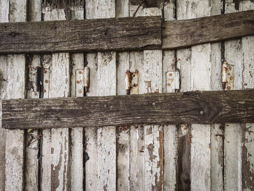 a wooden fence with a hole in it