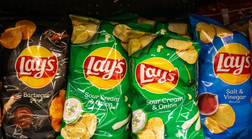 Several bags of lay's potato chips are displayed.