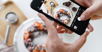 Homemade berry cake photographed with a smartphone, highlighting culinary creativity.
