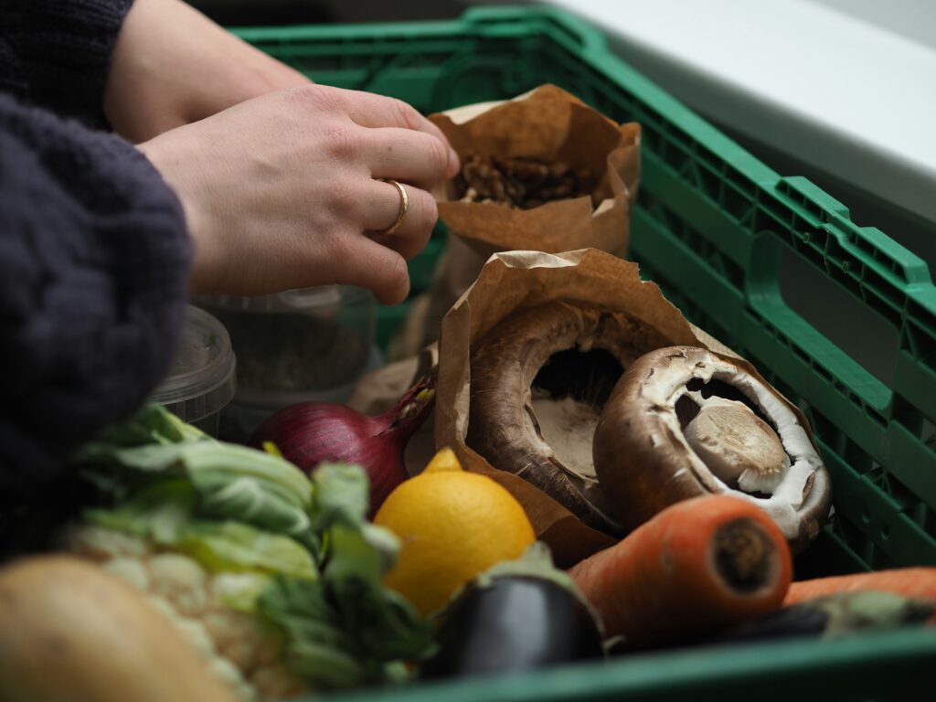 a person picking up food from a bin