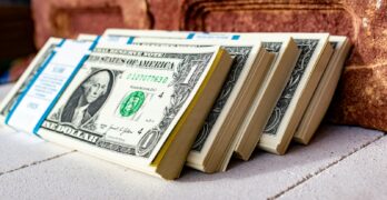 a stack of money sitting on top of a table