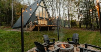 a small cabin with a fire pit in the yard