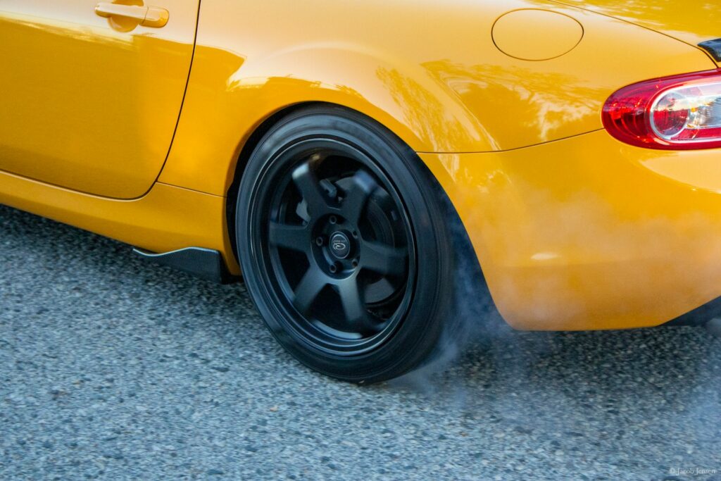 yellow car on gray concrete pavement