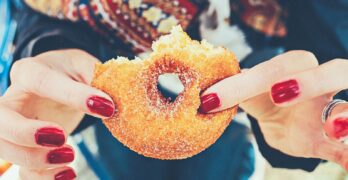 woman holding donut