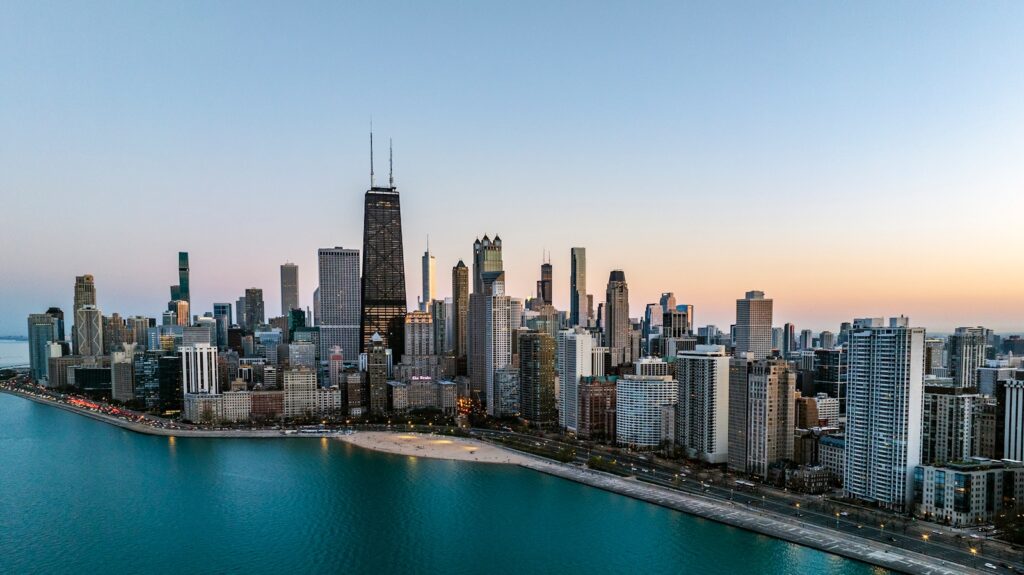 an aerial view of a large city next to a body of water