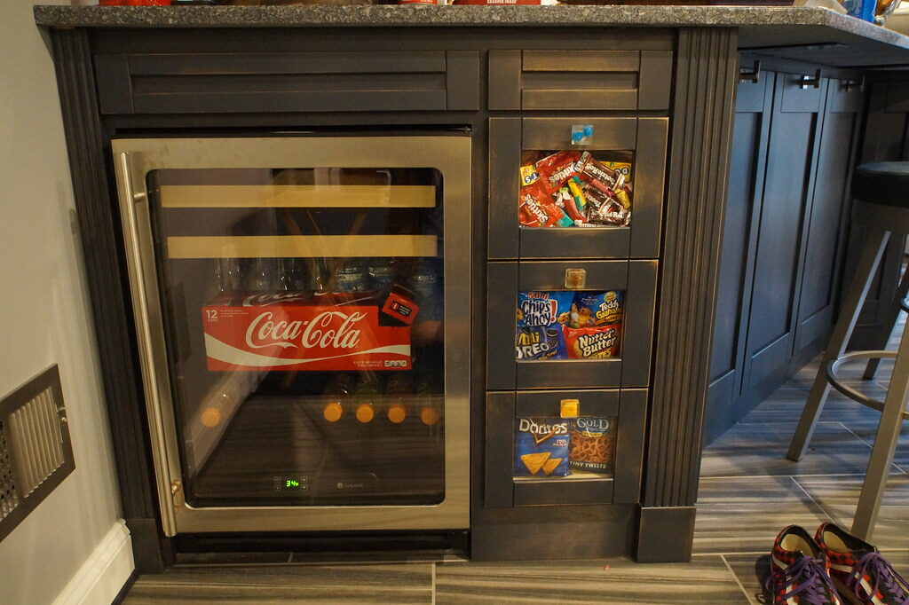 MINI- FRIDGE- with custom candy drawers facing outwards (for the kids) The homeowner custom made the knobs for the candy drawers- they have candy in them!