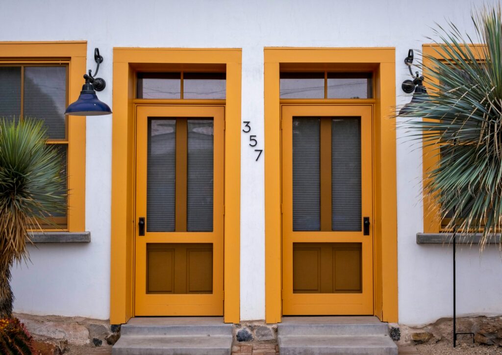 a yellow house with a couple of doors