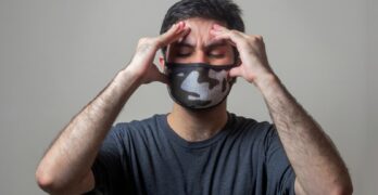 man in black crew neck t-shirt wearing black and white mask