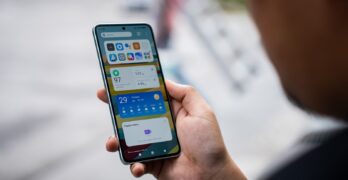 a person holding a cell phone in their hand