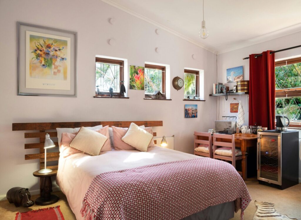 Warmly designed bedroom featuring wall art, wooden furniture, and indoor lighting.