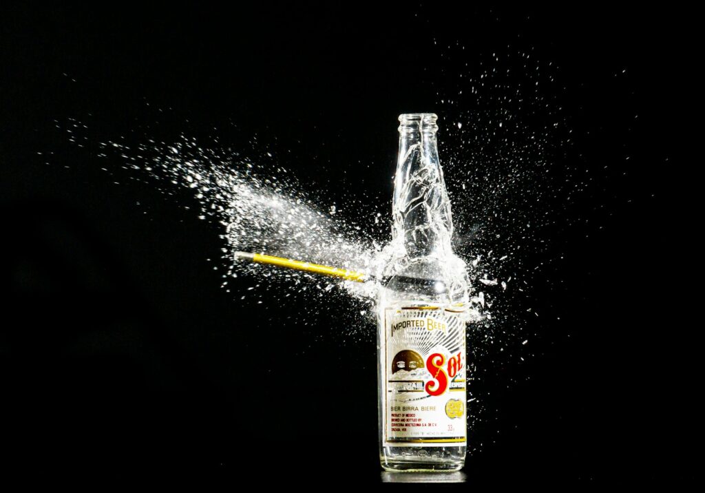 a bottle of alcohol is being splashed with water