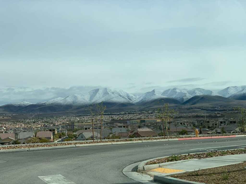gray concrete road near mountain during daytime