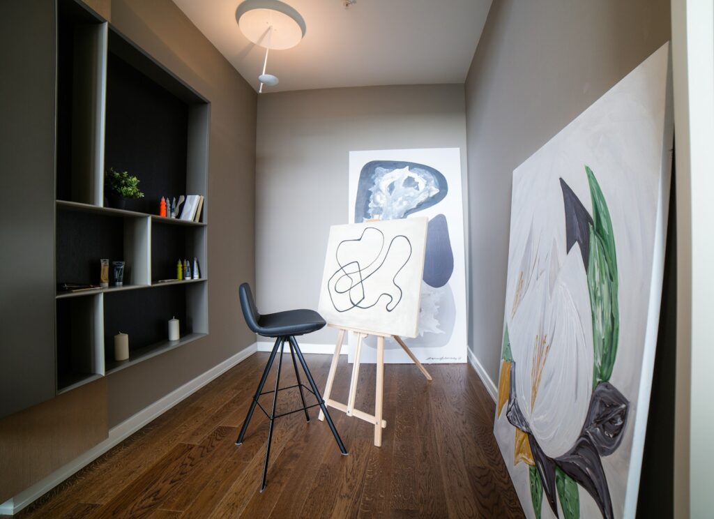 black and gray chair beside white wall