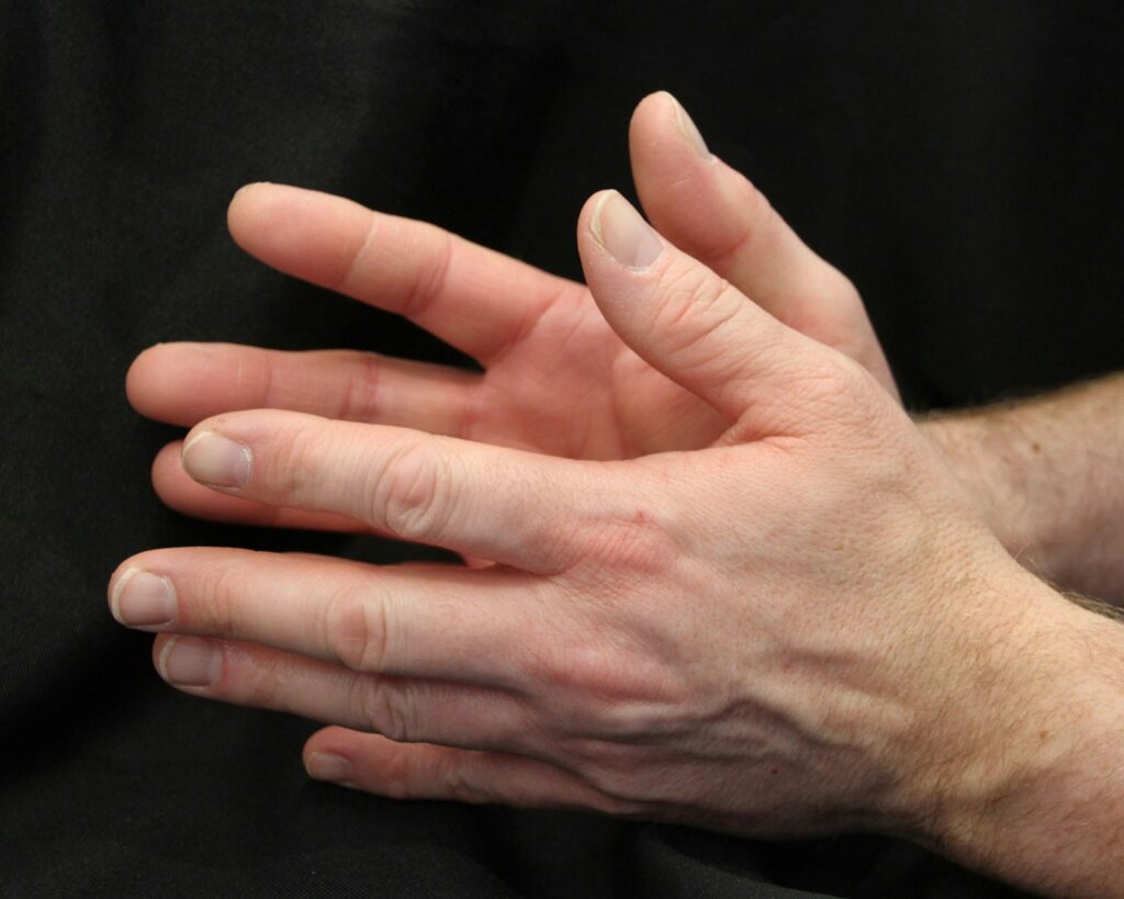 a close up of a person holding their hands together