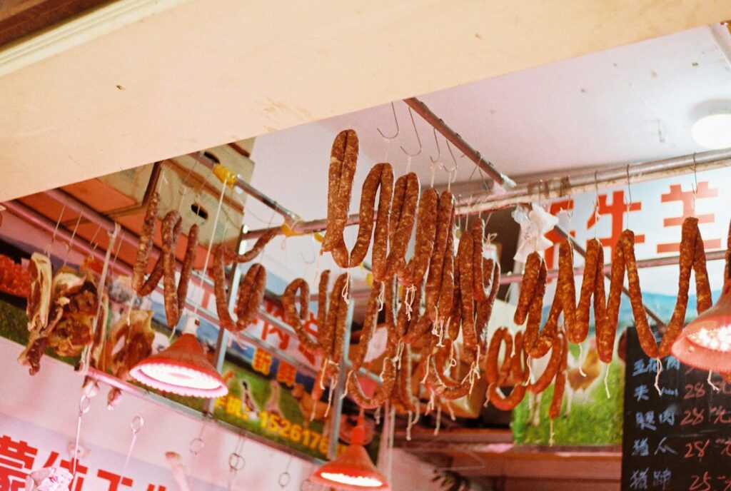 A store with a lot of donuts hanging from the ceiling