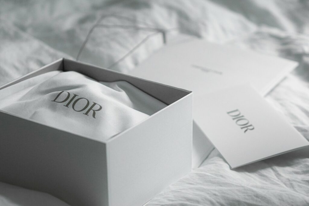 Dior box with cloth and card on white fabric