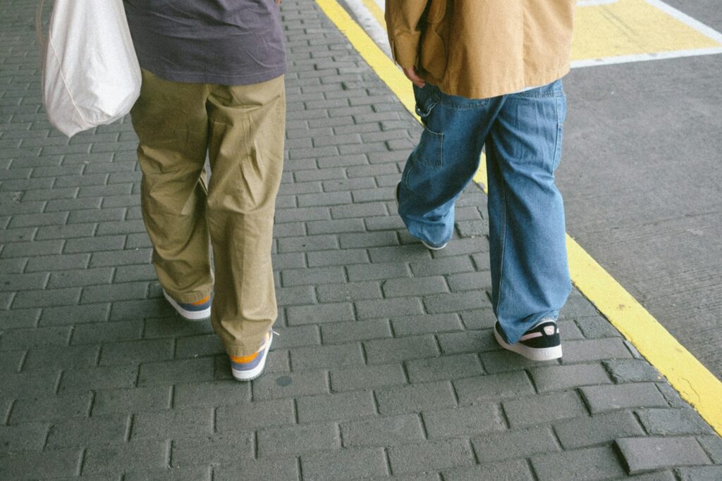 A couple of people walking down a street