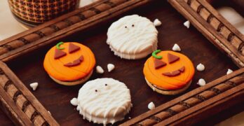 white and brown cupcakes on brown wooden tray