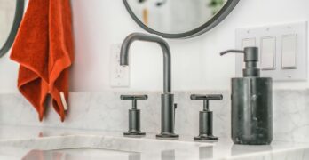 stainless steel faucet on white ceramic sink