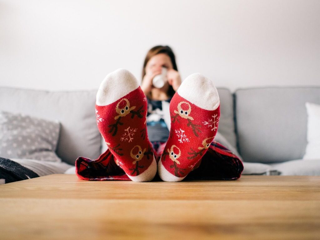 christmas wallpaper, feet, socks, living room, person, relaxing, table, couch, woman, lazy, pajamas, xmas, reindeer, relax, warm, home, sitting, female, human, comfortable, relaxation, cozy