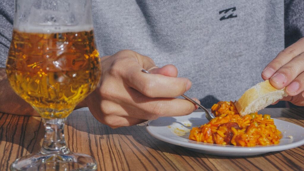 person holding stainless steel fork and knife