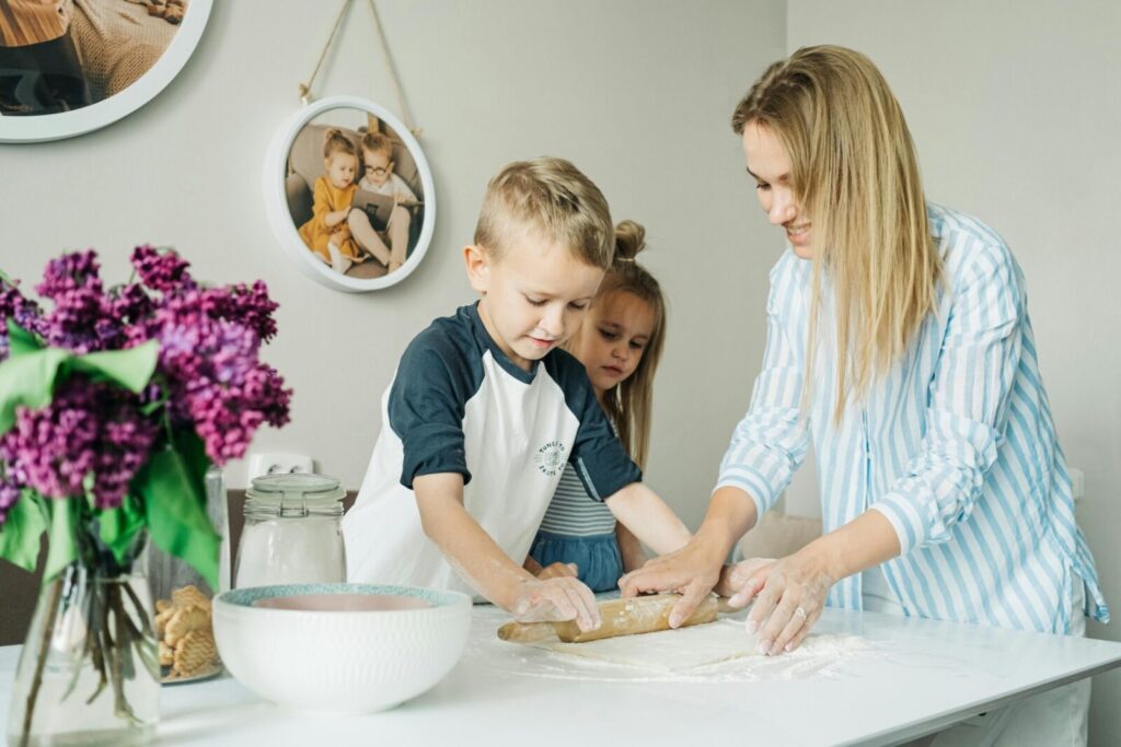 Mother and children enjoying a fun and messy baking session together at home.