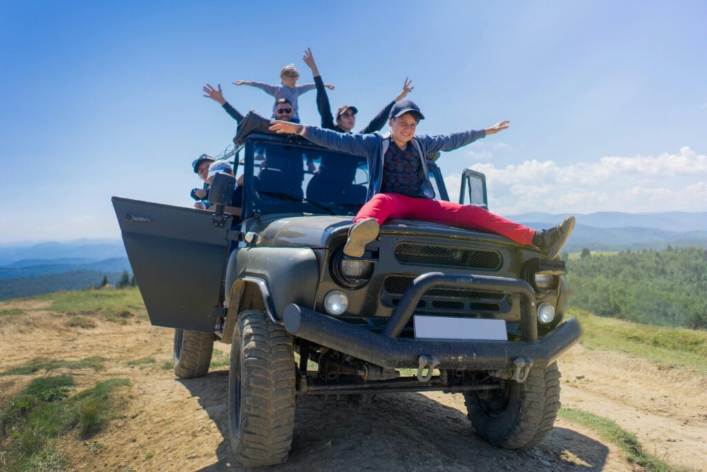 A joyful family enjoying an off-road adventure in Bukovel, Ukraine, on a sunny day.