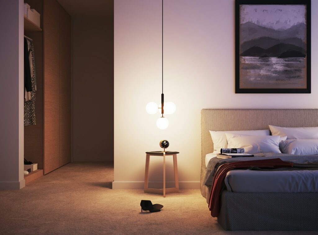 a bedroom with a bed and a painting on the wall