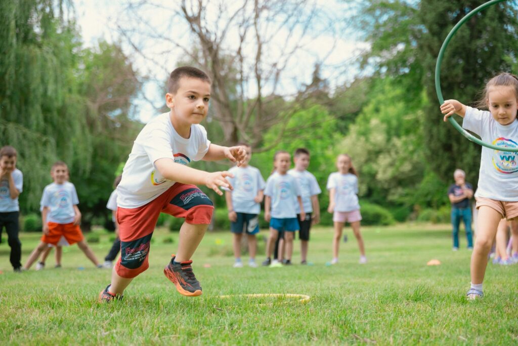 a group of young children playing a game of frisbee