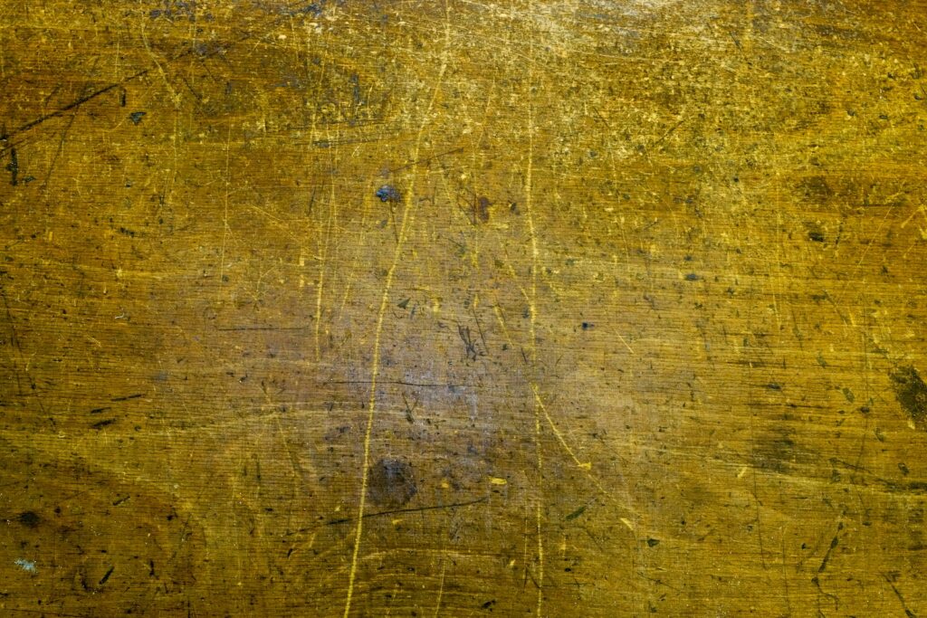 a close up of a wooden surface with yellow paint