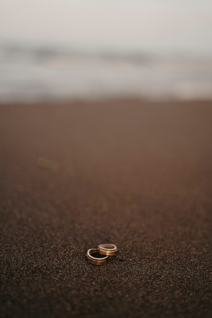 a couple of rings sitting on top of a sandy beach