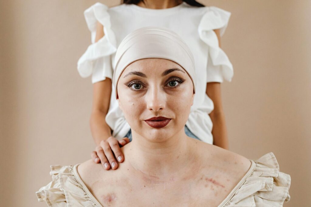 Intimate portrait of a courageous cancer survivor supported by a friend, highlighting strength and resilience.