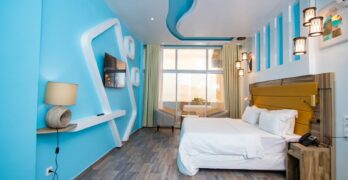 a bedroom with a bed and a mirror