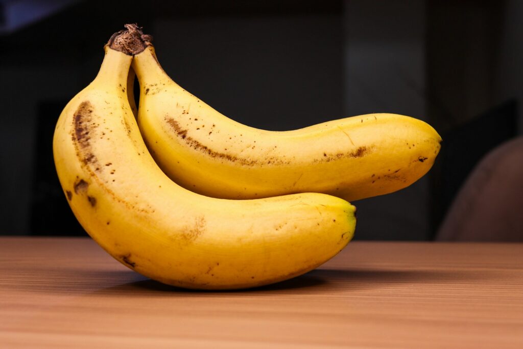 Two ripe bananas are shown on a table.