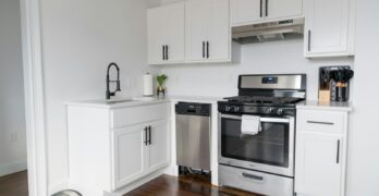 white wooden kitchen cabinet and white microwave oven