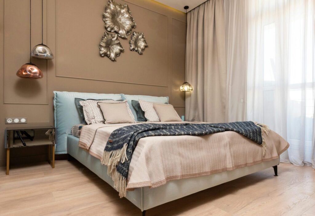 Elegant bedroom with modern decor and abundant natural light from large windows.