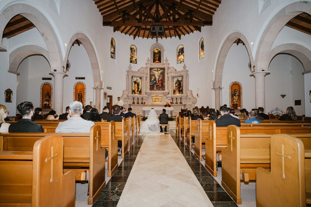 Wedding ceremony in a church with guests seated guests seated