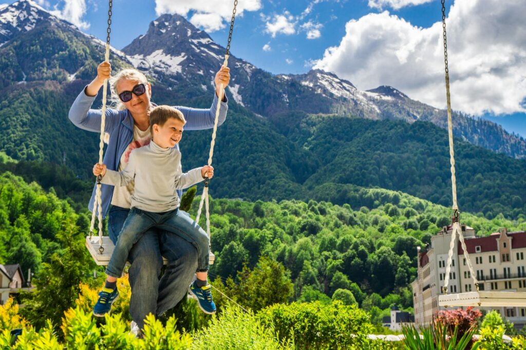 a man and a boy sitting on a swing