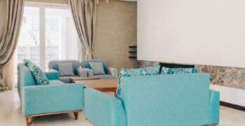 a living room filled with furniture and a chandelier