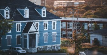 a blue house with a tree in front of it