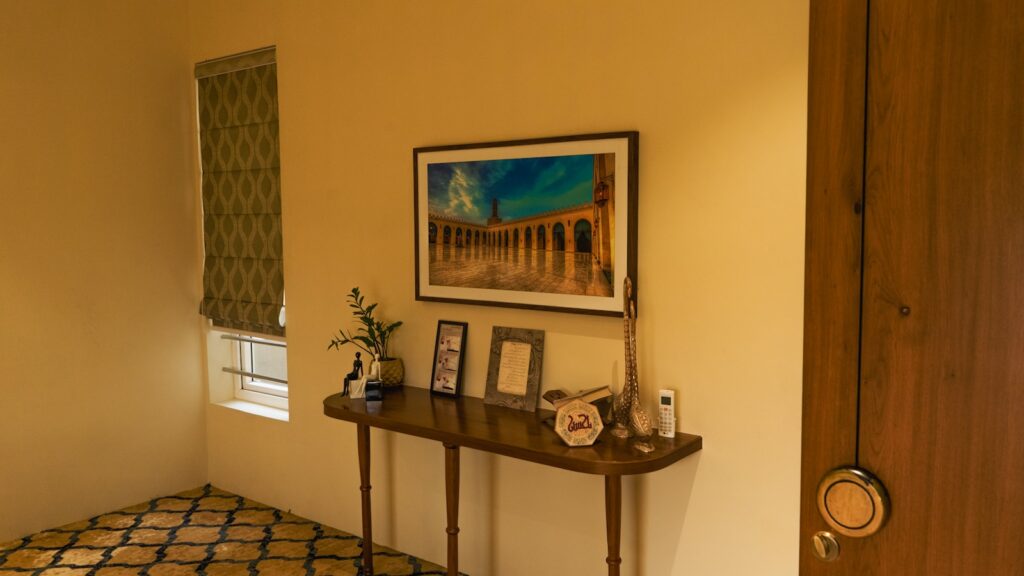 A hallway with an ornate table and artwork.