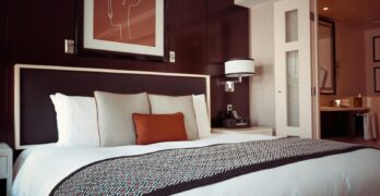 Cozy and modern hotel bedroom interior with elegant decor and soft lighting.