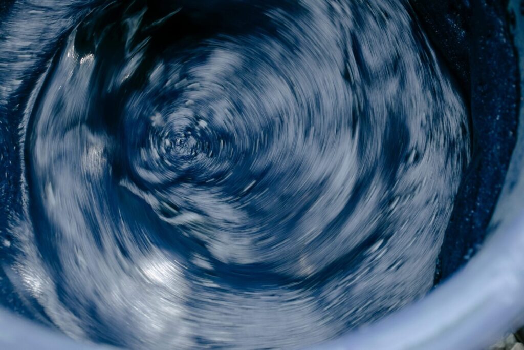 Abstract blue water swirl in motion, capturing energy and flow.