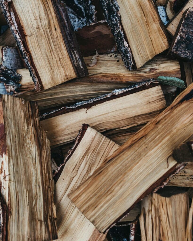 Detailed view of chopped firewood logs stacked together, showcasing natural textures.