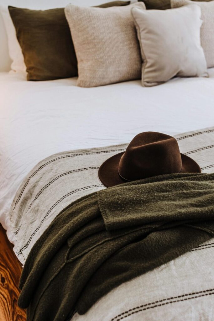 Stylish bedroom interior with a cozy hat and cushions, ideal for comfort and relaxation.