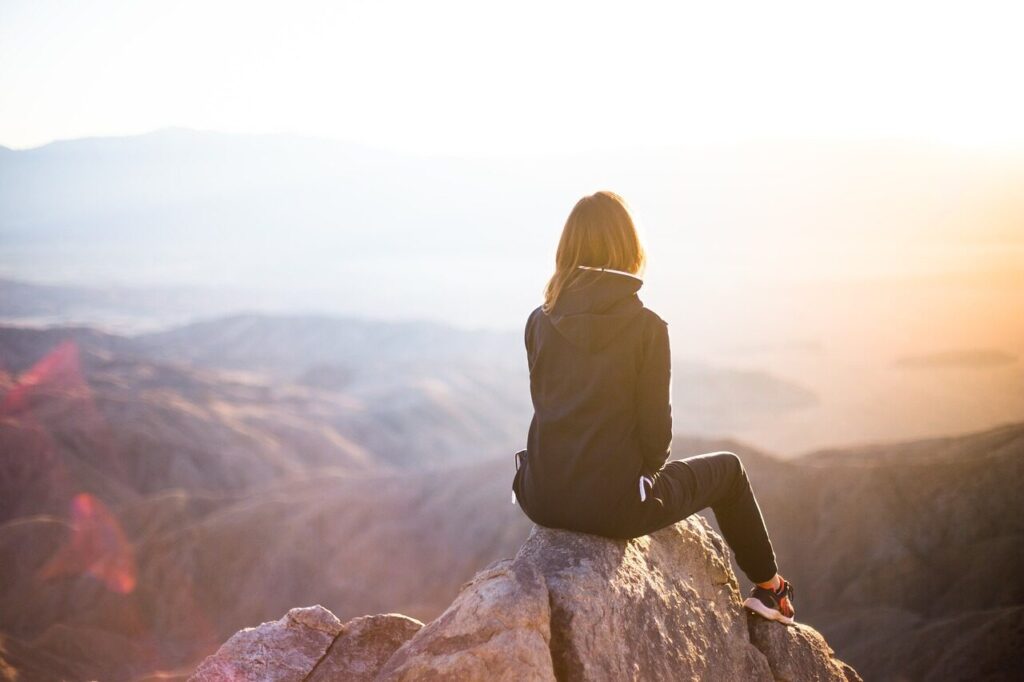 people, woman, travel, adventure, trek, mountain, rock, sunset, cliff, black, hoodie, jacket, nature, alone, thinking, freedom