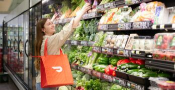 a woman is shopping in a grocery store