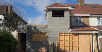 brown brick house under blue sky during daytime